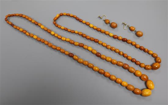 Two amber bead necklaces and a pair of amber earrings, gross weight 52 grams.